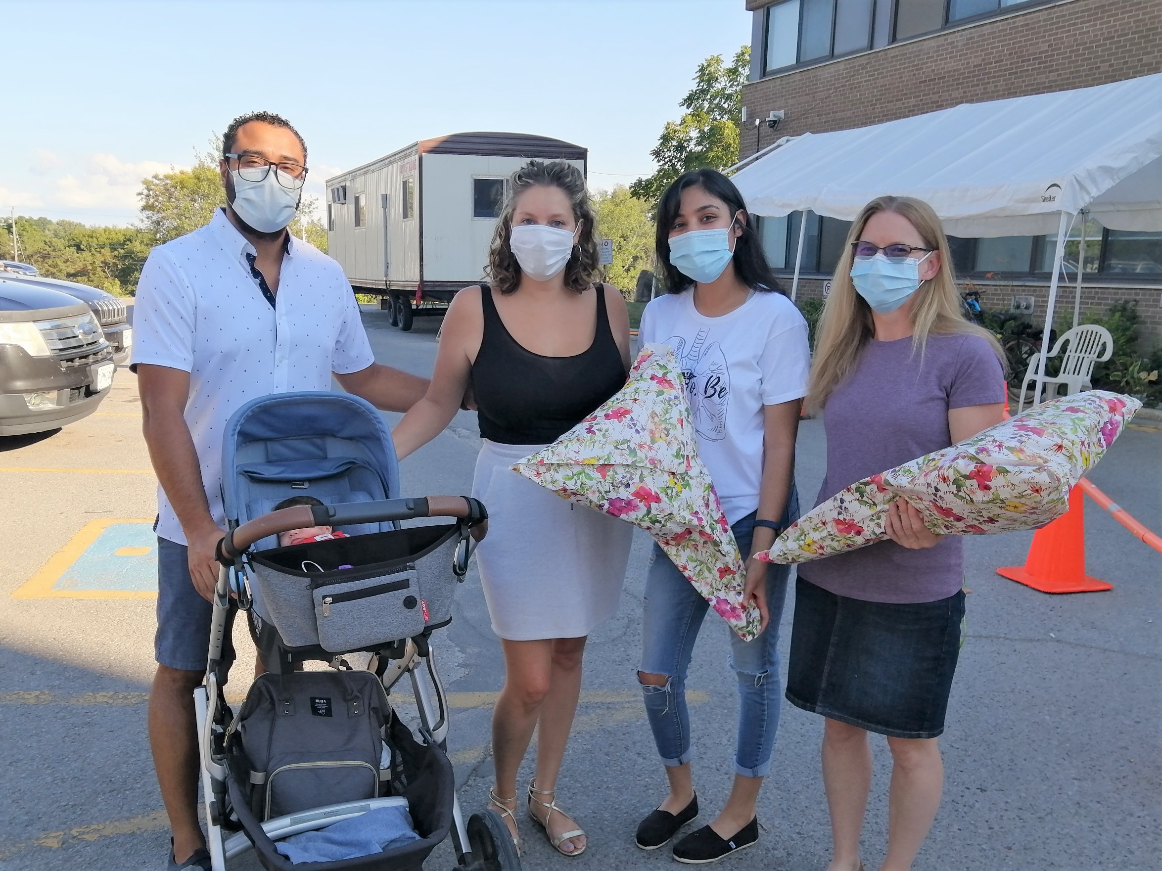 SMH staff pose with family who gave birth to baby on hospital parking lot